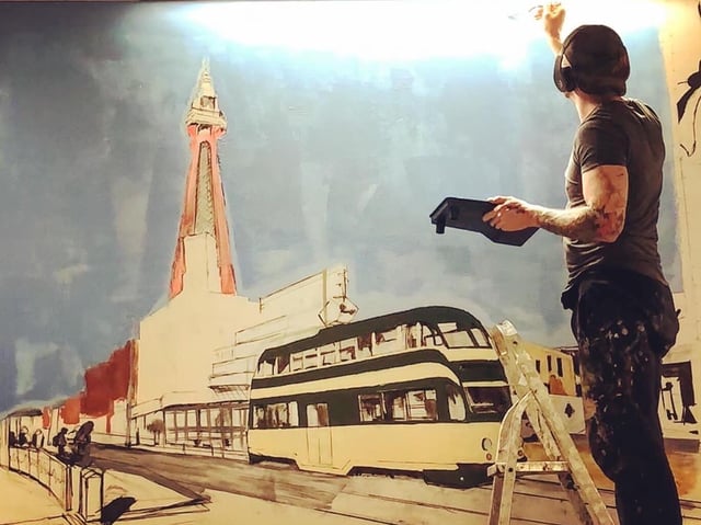 Adam at work on the mural