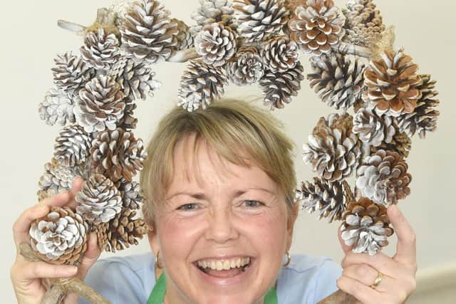Jane Littlewood, chairman of Cleveleys Coastal Community Group, with a wreath made from recycled pine cones.