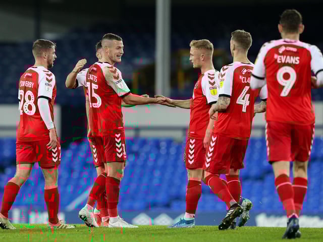 Fleetwood players congratulate Paul Coutts on scoring their second goal at Everton