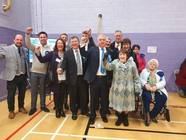 Mark Menzies celebrates his victory with party workers