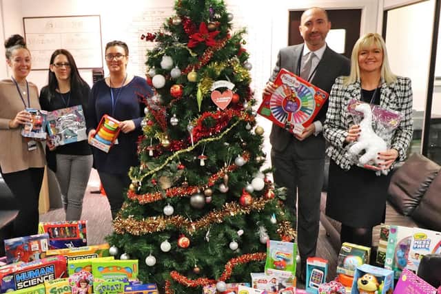 Staff at BES Utilities with some of the toys they have collected