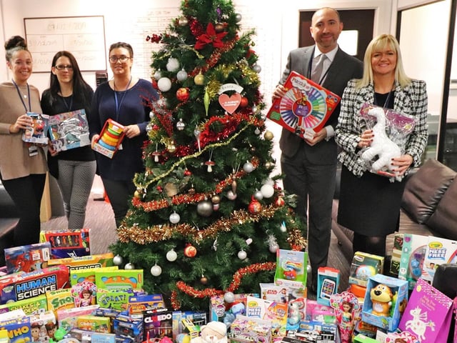 Staff at BES Utilities with some of the toys they have collected