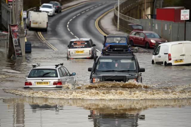 Motorists travel through floodwaters in Rotherham on November 8, 2019, following flash flooding the previous day (Oli SCARFF / AFP)