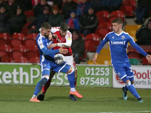 Ched Evans battles for the ball against Gillingham's Max Ehmer