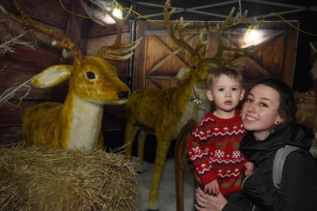 Hollie Albero with Valentino, one, visiting the reindeer.