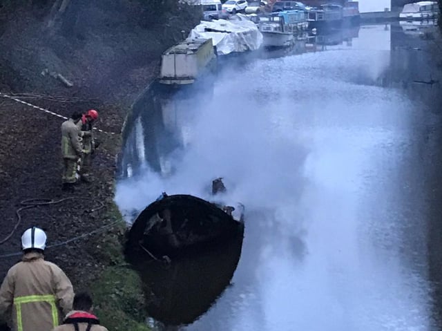 The wreck of the barge after the fire. Picture: Ian Armistead