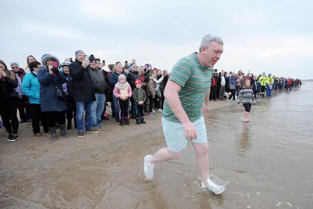 A crowd of around 500 people cheer on the New Year's Day dippers.