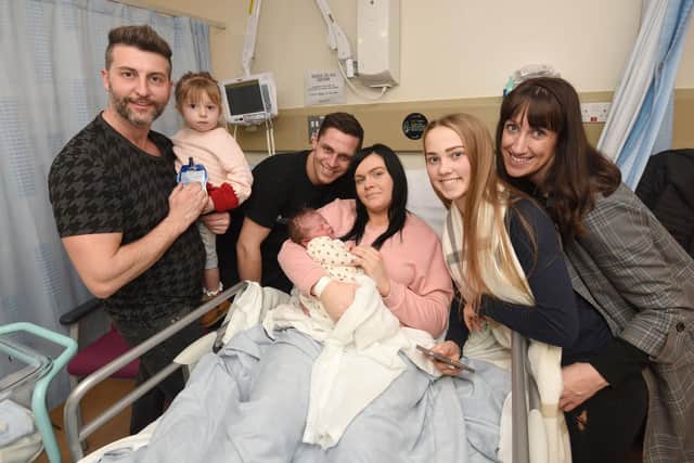 Jullian Christopher Bevan was born on New Year's Day at Victoria Hospital weighing 8lb 13oz at 11.41am to mum Chloe Howell and dad Nicholas Bevan.  They are pictured centre with family L-R Luke Waterhouse with 3-year-old Isabelle-Rose and Olivia, 14, and Natalie Bevan.