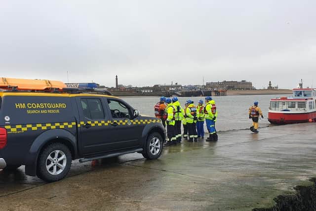 A JCB forklift with an extendable arm had to brought to the slipway to recover the upturned vehicle. Pic: HM Coastguard Fleetwood