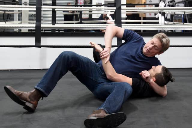 WWE star William Regal shows gym boss Ryan Davies a few moves