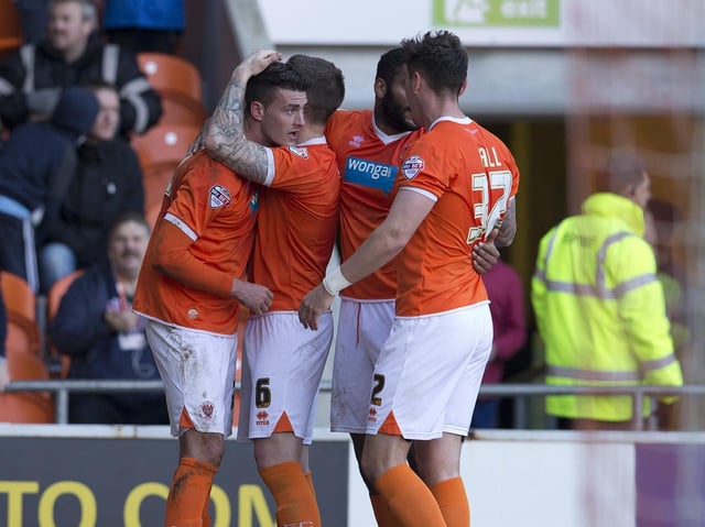 Gary Madine (left) celebrates a Championship goal for Blackpool against Leeds United in 2015