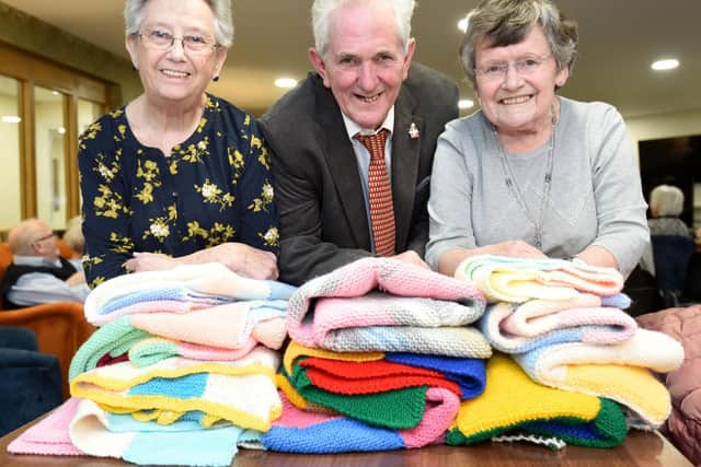 Members of the craft group at Crocus Court have donated knitted blankets to Len Curtis from Donna's Dream House.  He is pictured with Jill Snowball and Vera Lowis