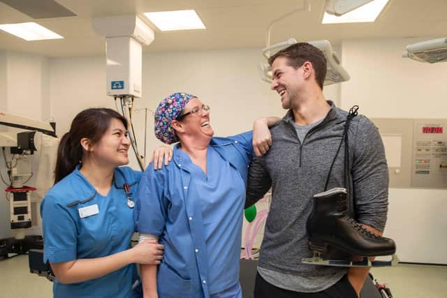 Dancing on Ice professional dancer Tom Naylor gets the support from Nurse Maria Katrina Apor (left) and Girsty Spencer (Operating Dept Practitioner) as he pays a visit to the Spire Fylde Coast Hospital in Blackpool. Picture: Spire Fylde Coast Hospital/Jason Roberts