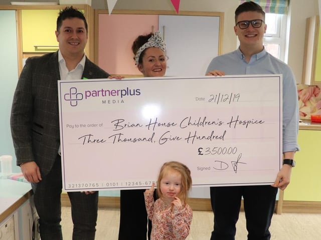 Digital coordinator Dan Moore and Kyle Bonar hand over the cheque for 3,500 to Lauren Codling from Brian House children's hospice, with Elizabeth. Picture: Partner Plus Media