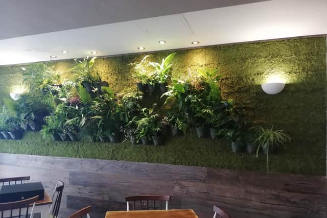 The back wall of Thyme is adorned by real plants provided by local suppliers.