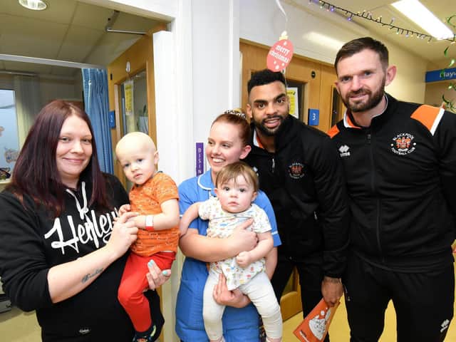 Matthew Savage-Grattan with his mum Zoe (far left, holding Matthew) and sister Isabel met Blackpool FC stars at Blackpool Victoria Hospital last month