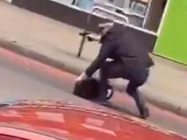 Screengrab from video taken with permission from the Twitter feed of @gullyyt of an armed police officer on Streatham High Road (Picture: Gully/PA Wire)