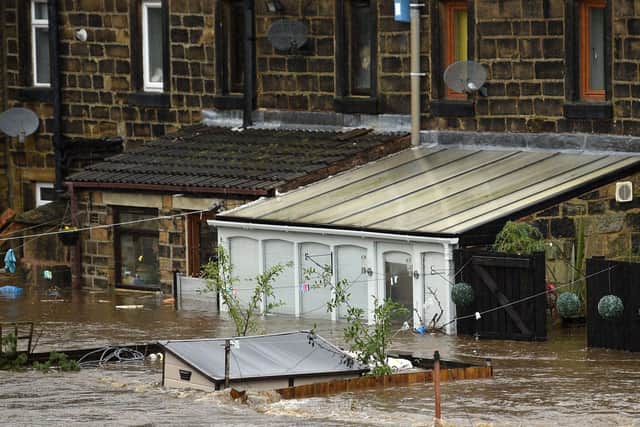 Flooded houses are pictured in Mytholmroyd, northern England, on February 9, 2020, after the River Calder burst its banks as Storm Ciara swept over the country