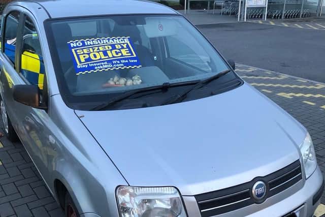 Some of the allegedly pilfered produce, including carrots and mushrooms, can be seen on the dashboard of the seized Fiat. Pic: Lancashire Road Police