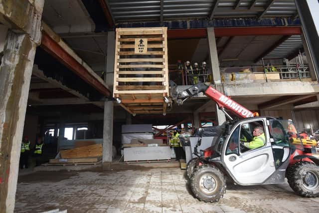 The crate with the elephant inside is hoisted up to the first floor