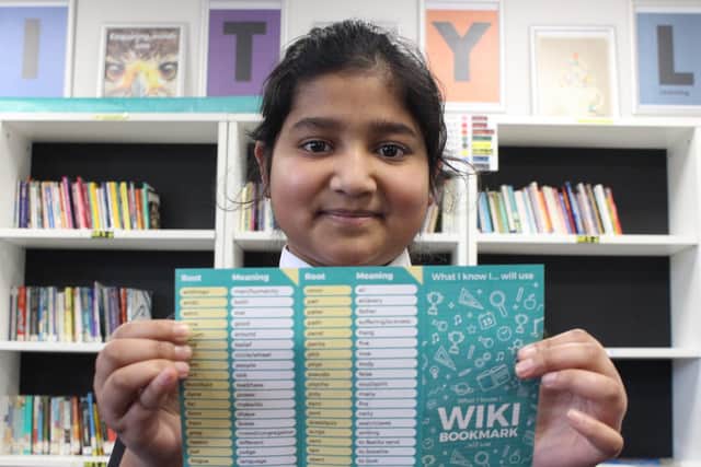 Unity Academy pupil -   Halima Amin with the bookmarks