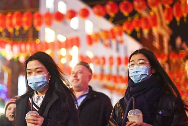 People wearing masks in China Town, London. Picture: Victoria Jones/PA Wire