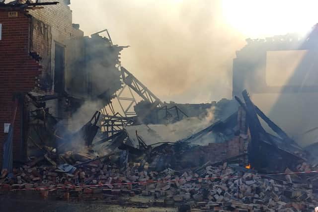 The building partly collapsed after being ravaged by fire this morning
