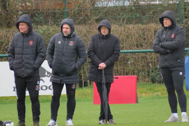 Tommy Johnson, David Dunn, new head coach Neil Critchley and Steve Banks watch on from the sidelines