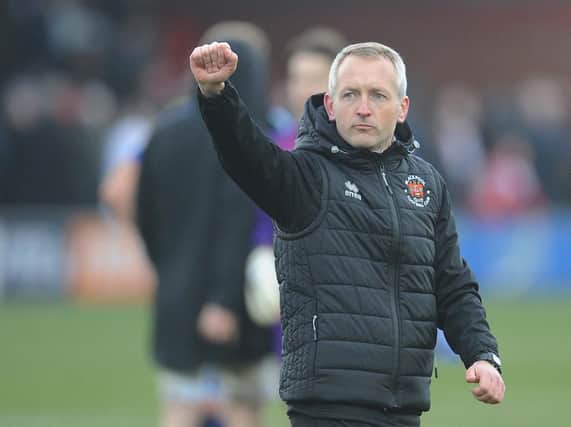 Neil Critchley salutes the Blackpool fans after the final whistle
