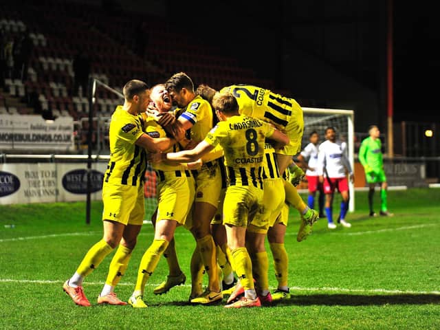 Fylde celebrate Alex Whitmore's stoppage-time winner at Dagenham and Redbridge Picture: STEVE MCLELLAN