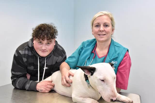 Jake Hartill, from Blackpool, with his bull terrier Milly who needed emergency surgery after swallowing a bone and vet Jennifer Jackson