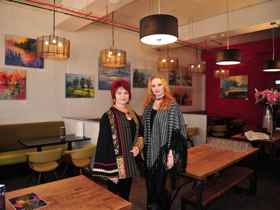 Anna Ravliuc and Irina Rojin with their Honeycomb Metamorphosis Art Exhibition on display at the Hive Coffee shop in Blackpool