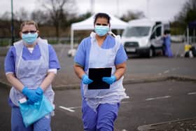 NHS nurses wait for the next patient at a drive through Coronavirus testing site
