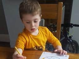 Four-year-old Isaac paints an Easter egg in Marton.