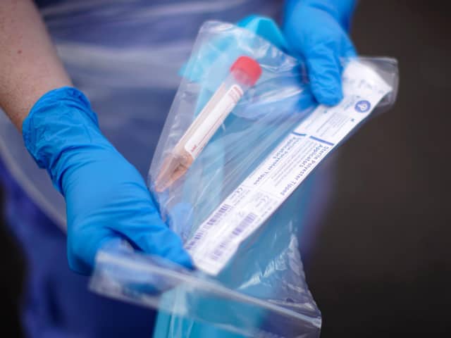 A NHS nurse holds a Coronavirus testing kit
