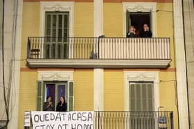 People applaud from a balcony during a flash mob called through social media and messaging platforms, aimed to thank workers in the fight against coronavirus on March 15, 2020 in Barcelona, Spain