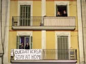 People applaud from a balcony during a flash mob called through social media and messaging platforms, aimed to thank workers in the fight against coronavirus on March 15, 2020 in Barcelona, Spain