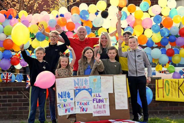 The Wilson-Smith family with their rainbow balloons and posters.