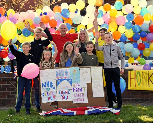 The Wilson-Smith family with their rainbow balloons and posters.