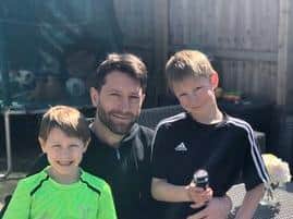 Dobbie pictured with his sons Maxwell and Jack...before having their heads shaved