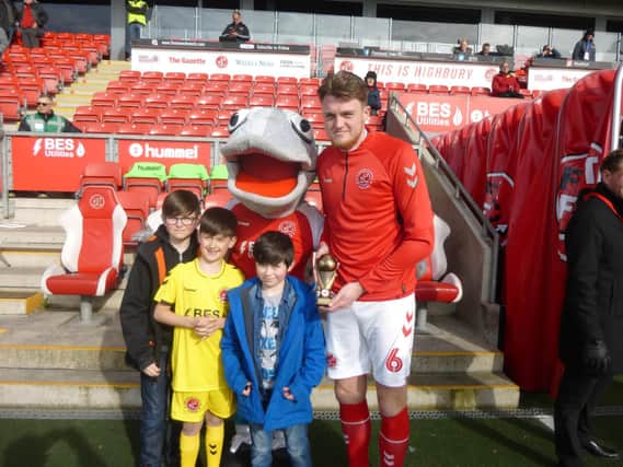 Nathan Mitchell (second left) is among those making the latest Fleetwood Town Official Supporters' Club player of the month award to Harry Souttar