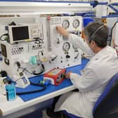 An employee from Smiths Medical tests one of the new ventilators bound for UK hospitals under the Ventilator Challenge UK  consortium