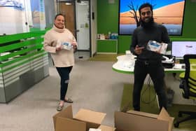 Dr Zuber Bagasi and Synergy HR manager Leah Shaw with boxes of the facemasks being donated to local communities and hospitals