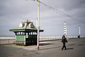 A lone police officer patrols the promenade on Blackpool's Golden Mile as people and businesses observe the pandemic lockdown