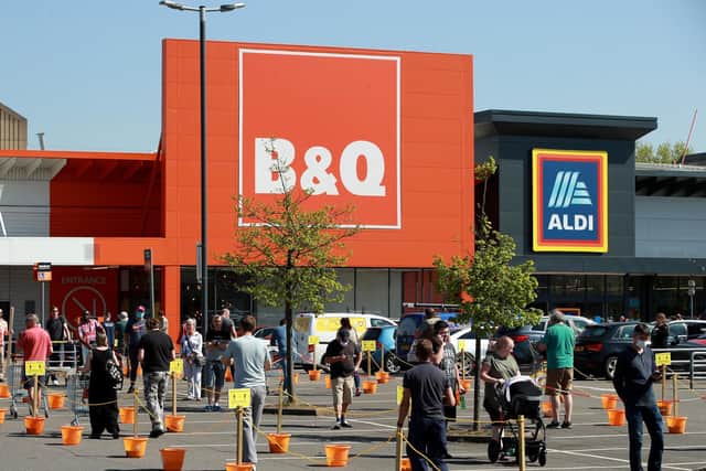 Shoppers queue at a recently re-opened B&Q hardware store