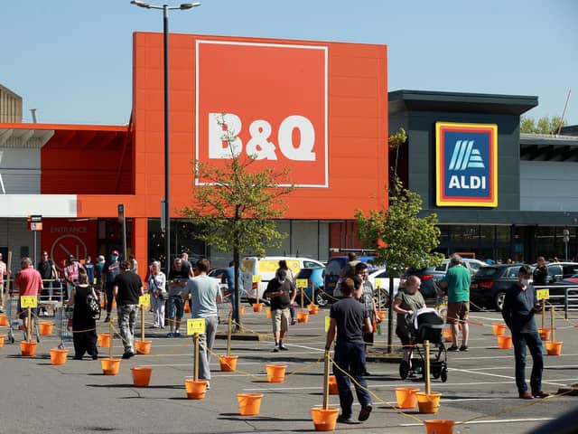 Shoppers queue at a recently re-opened B&Q hardware store