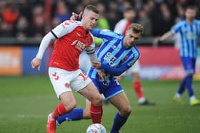 Paul Coutts is challenged by Blackpool's Kiernan Dewsbury-Hall at Highbury in March