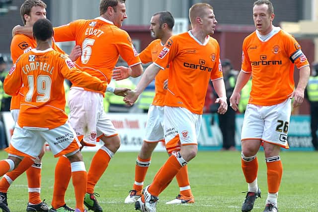 Keith Southern is mobbed by his Blackpool teammates after levelling for the Seasiders