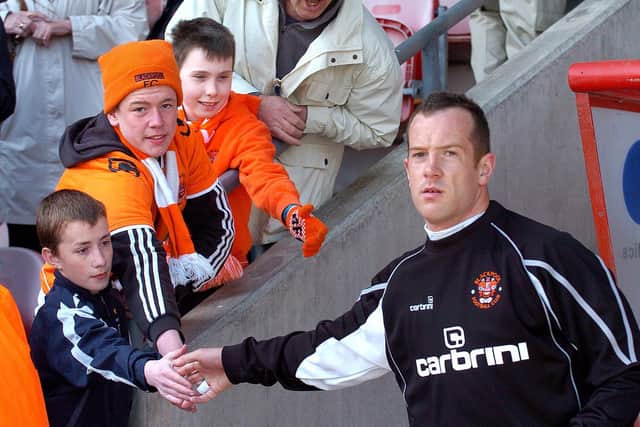 Charlie Adam makes the day of delighted young Blackpool fans with a handshake on emerging from the tunnel