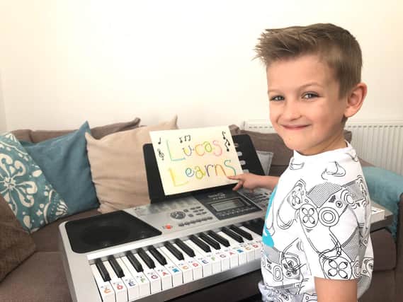 Unity Academy pupil Lucas Algar, six, is learning as many songs as he can in a month to raise money for Trinity Hospice